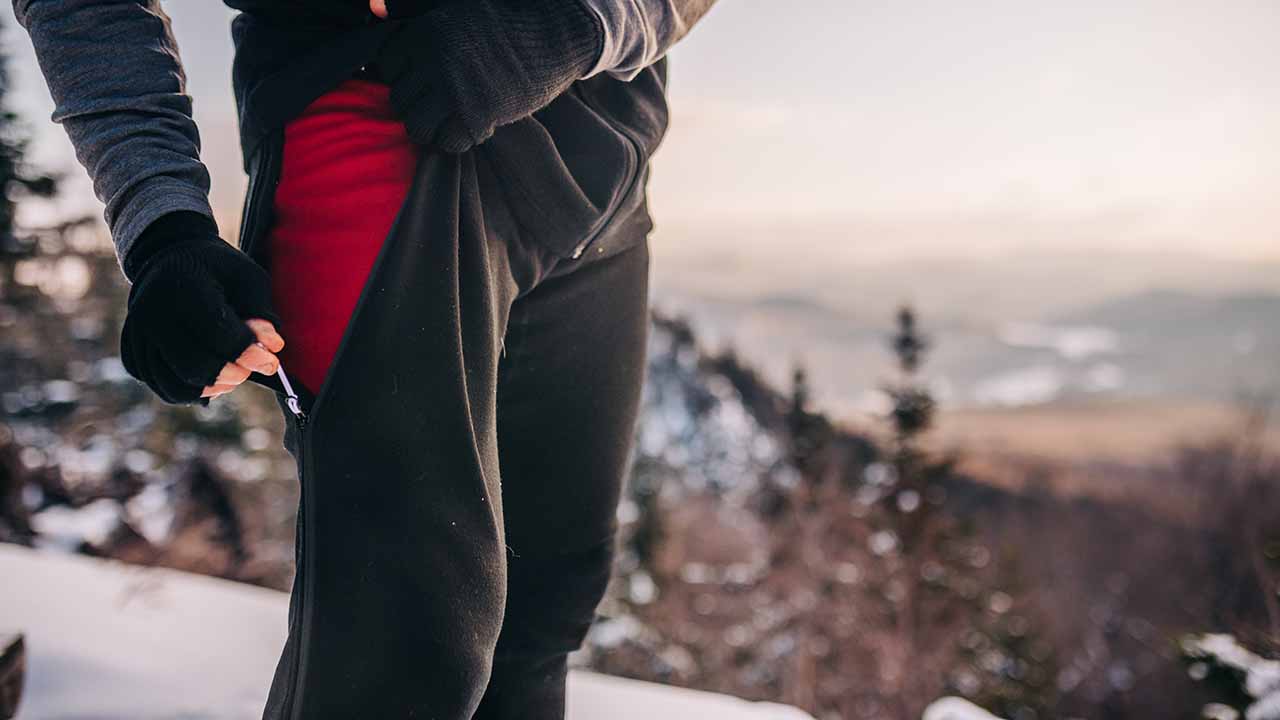 man wearing zip off expedition weight bottoms