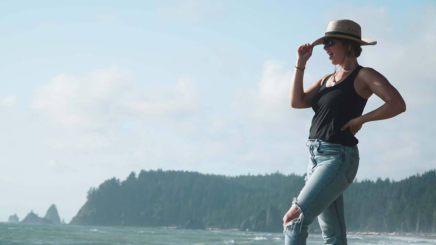 woman on beach wearing minus33 merino wool micro racerback tank top