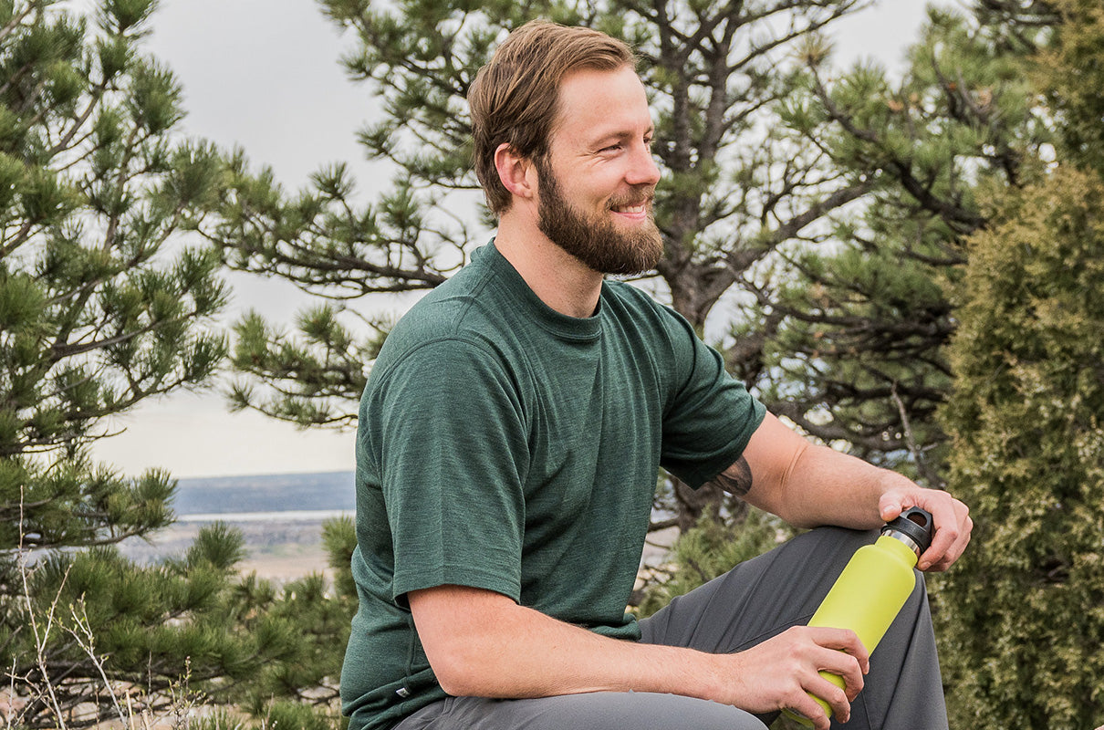 man hiking wearing 100% merino wool base layer tshirt