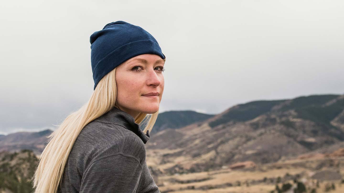 Woman hiking while wearing Minus33 merino wool ridge cuff beanie