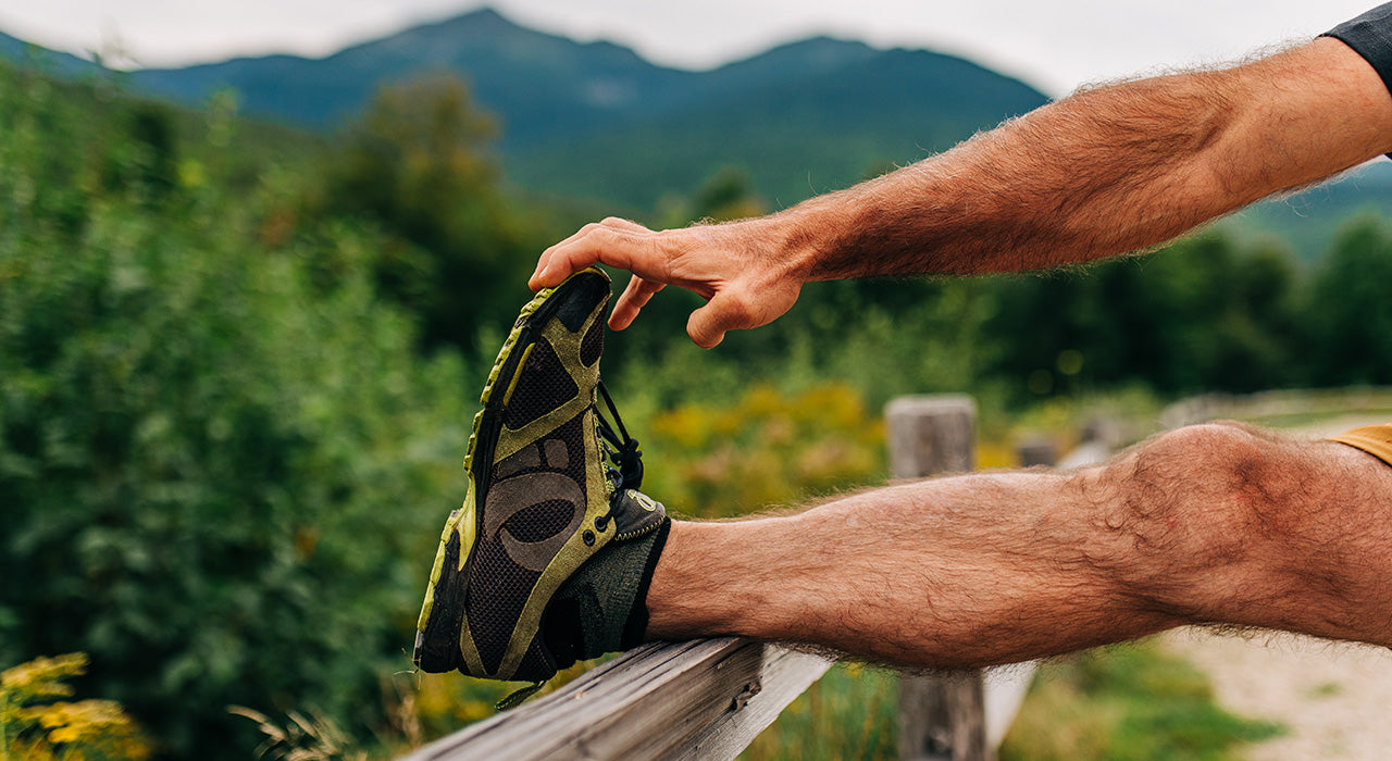 man stretching before running with ankle sock