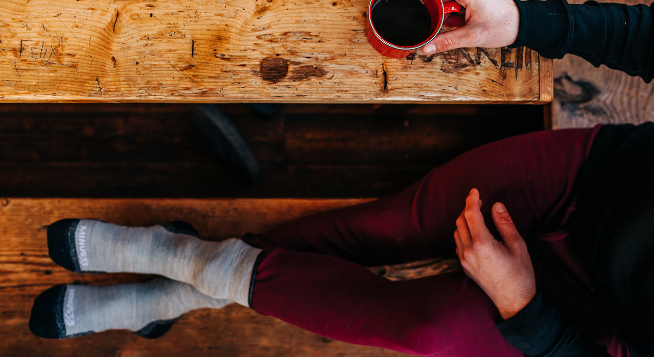 Man sitting drinking coffee wearing midweight bottoms