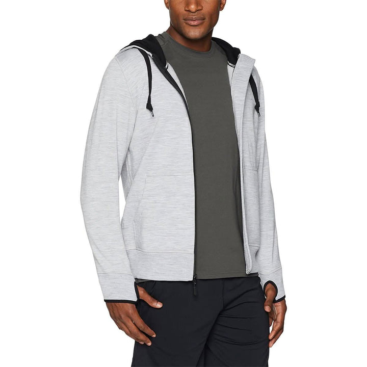 A man models the heavyweight brushed wool Kodiak Fleece Hoodie, crafted with thumbholes and a drawstring to bundle you up for wicked cold days! #color_ash-gray
