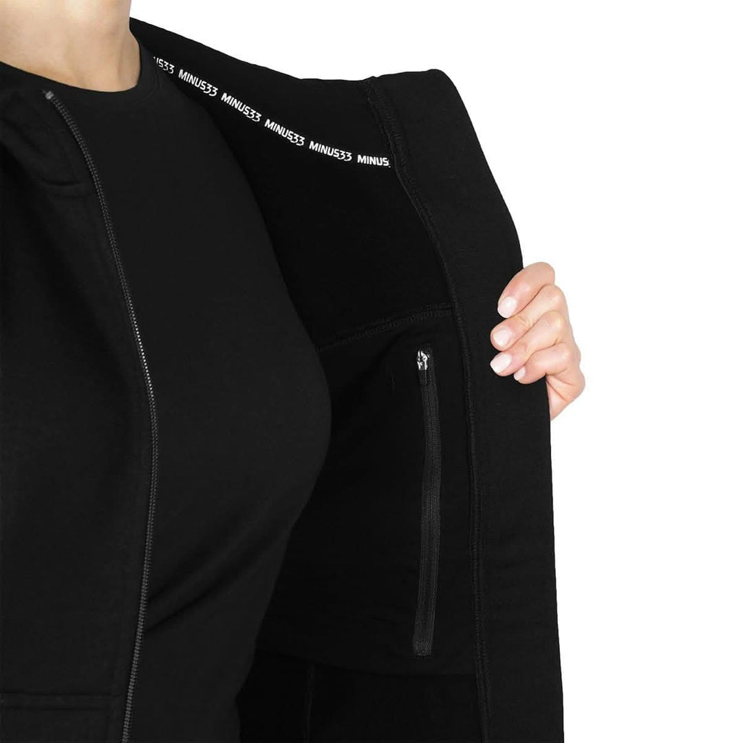 A closeup on the hoodie's interior, displaying the zipper of the hidden pocket and the super soft brushed wool. The heavyweight brushed wool Kodiak Fleece Hoodie, crafted with thumbholes and a drawstring to bundle you up for wicked cold days! #color_black
