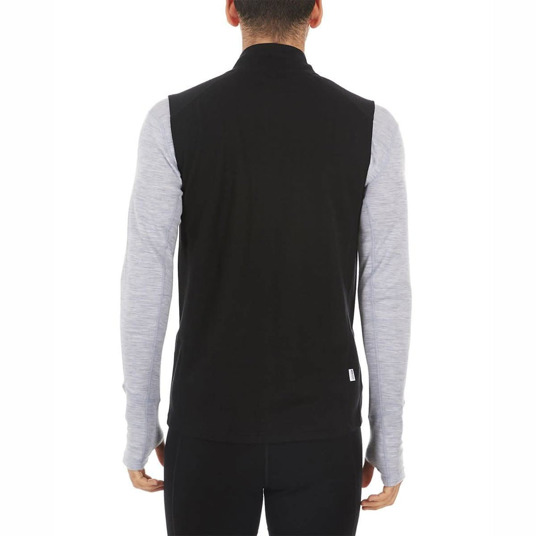 A man models the heavyweight merino wool full-zip vest #color_black