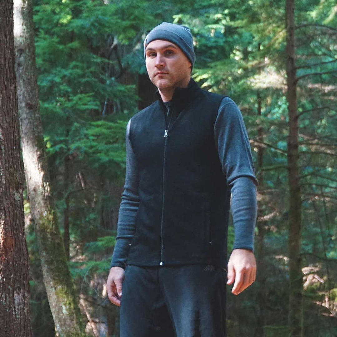 A man models the heavyweight merino wool full-zip vest #color_black
