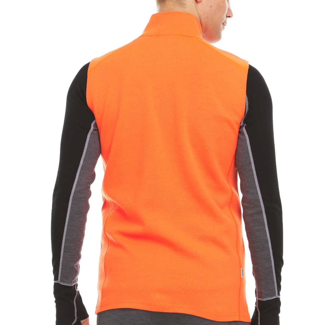 A man models the heavyweight merino wool full-zip vest #color_blaze-orange