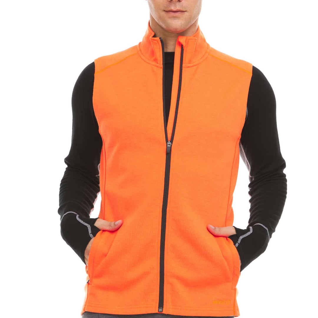 A man models the heavyweight merino wool full-zip vest #color_blaze-orange