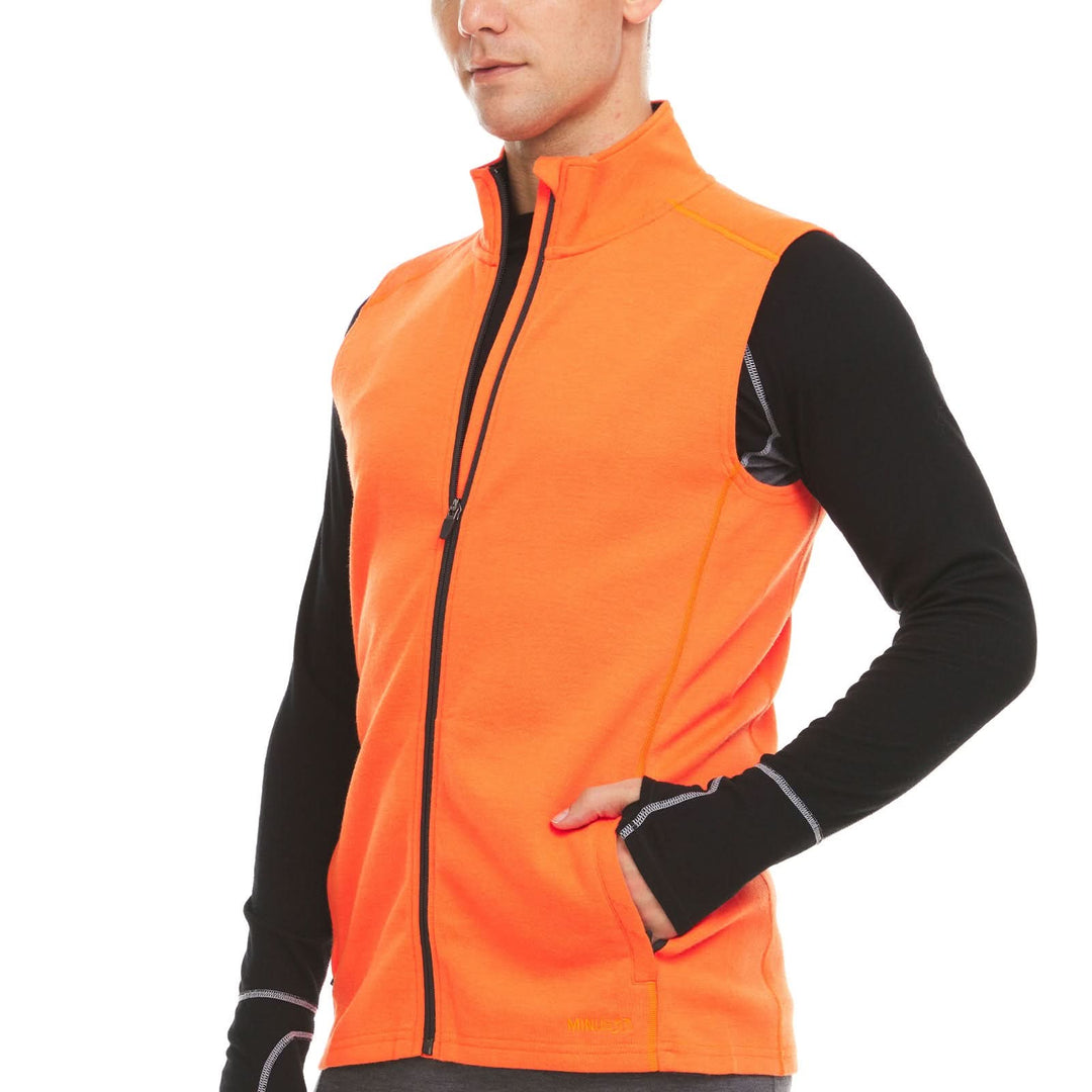 A man models the heavyweight merino wool full-zip vest #color_blaze-orange