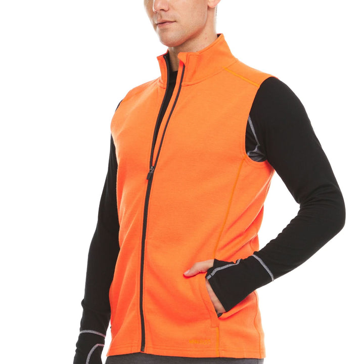 A man models the heavyweight merino wool full-zip vest #color_blaze-orange
