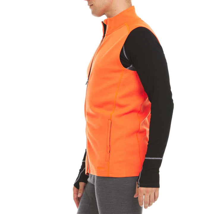 A man models the heavyweight merino wool full-zip vest #color_blaze-orange