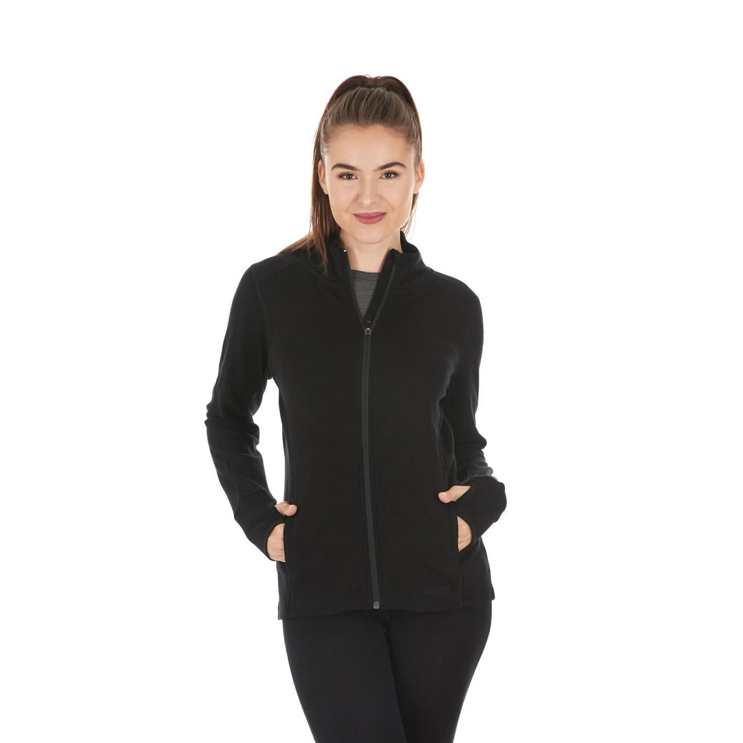 A woman models a hundred percent merino wool heavyweight full zip sweater. This outer layer features a two and a half inch mock neck collar, two zippered pockets, and thumbholes. #color_black