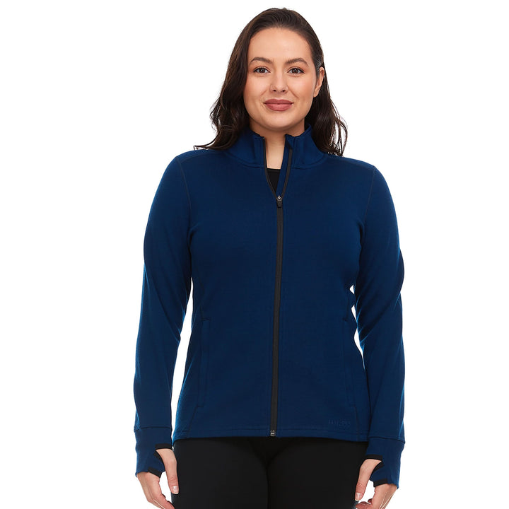 A woman models a hundred percent merino wool heavyweight full zip sweater. This outer layer features a two and a half inch mock neck collar, two zippered pockets, and thumbholes. #color_navy