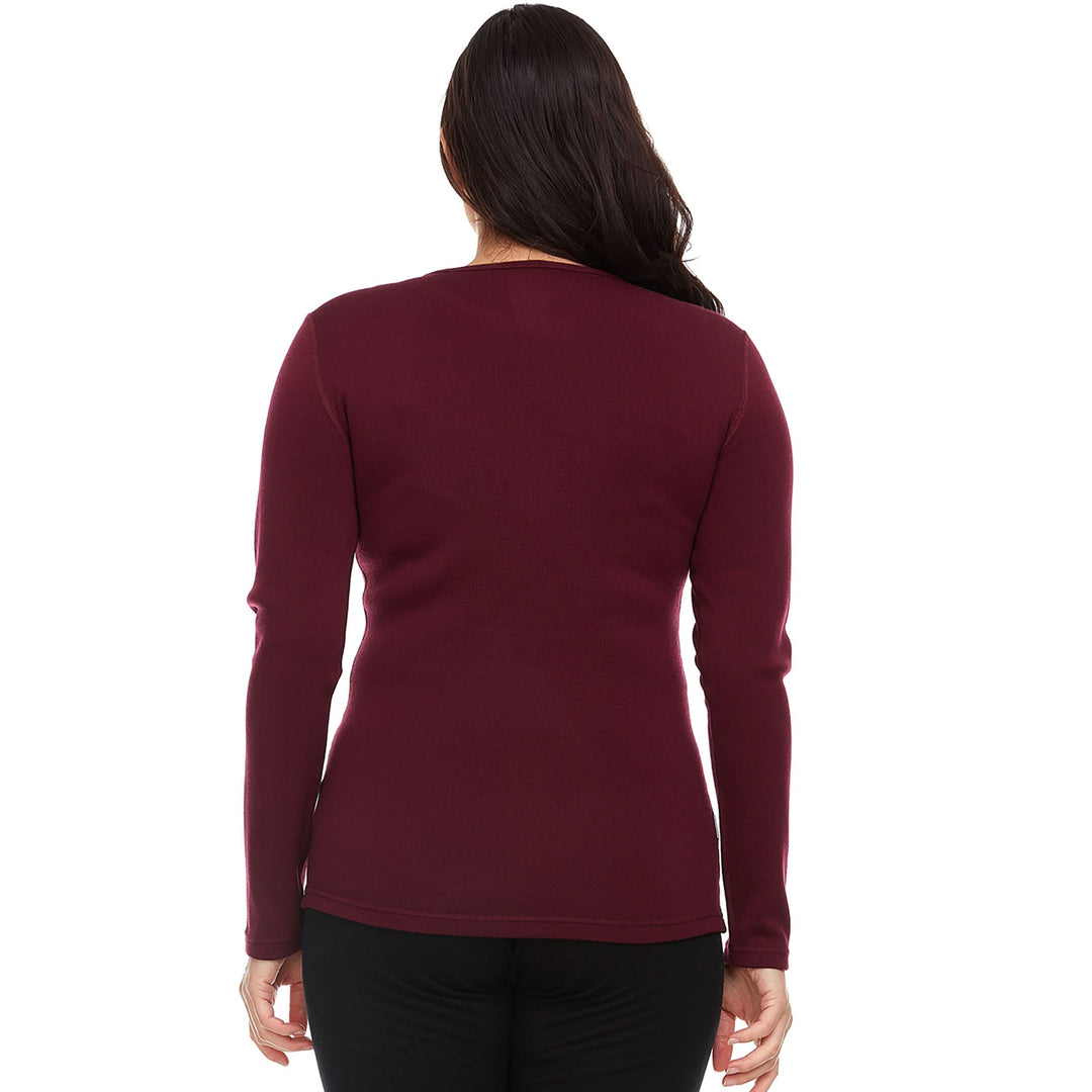 A woman models the one hundred percent merino wool heavyweight women's base layer crew top. This super soft top has a princess cut style for a more flattering fit. #color_burgundy
