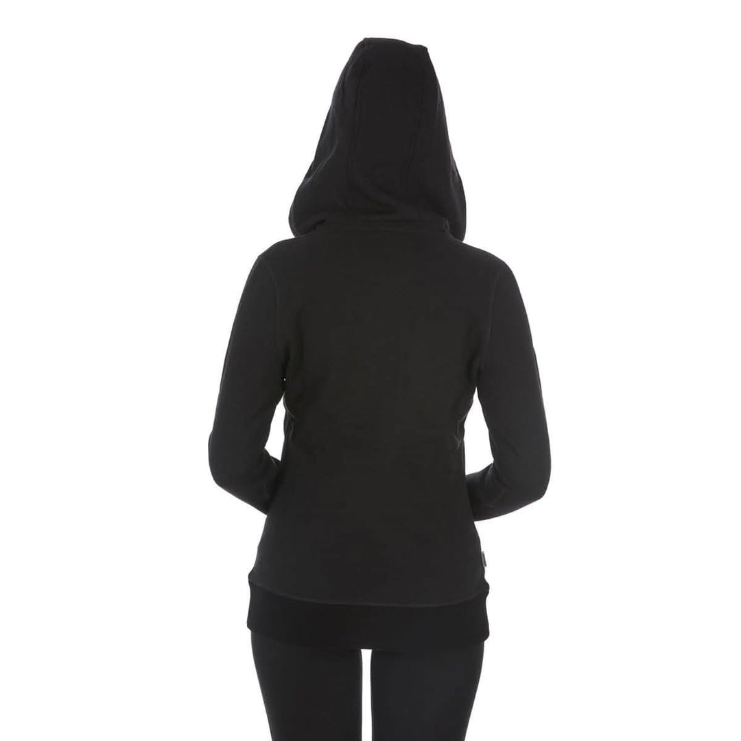 A woman models the heavyweight merino wool brushed fleece hoodie. The hoodie features a large hood with drawstrings, thumbholes, two pockets, and an interior stash pocket inside. #color_black