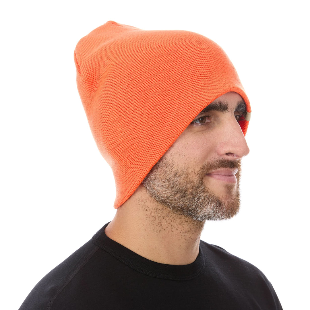 A man models a heavyweight, super soft, one hundred percent merino wool beanie. This heavyweight beanie is the warmest hat that we offer, perfect for hiking through the White Mountains, or sitting at a bonfire in January. #color_blaze-orange
