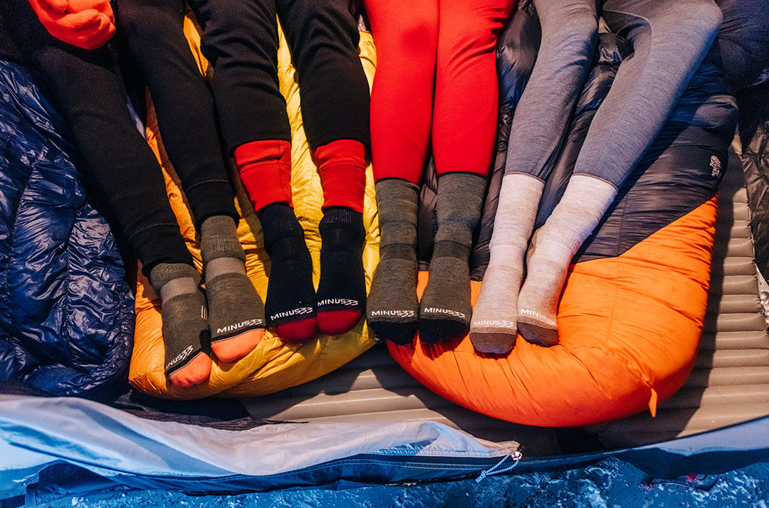 group of friends wearing their NH USA made Mountain Heritage merino wool socks while camping