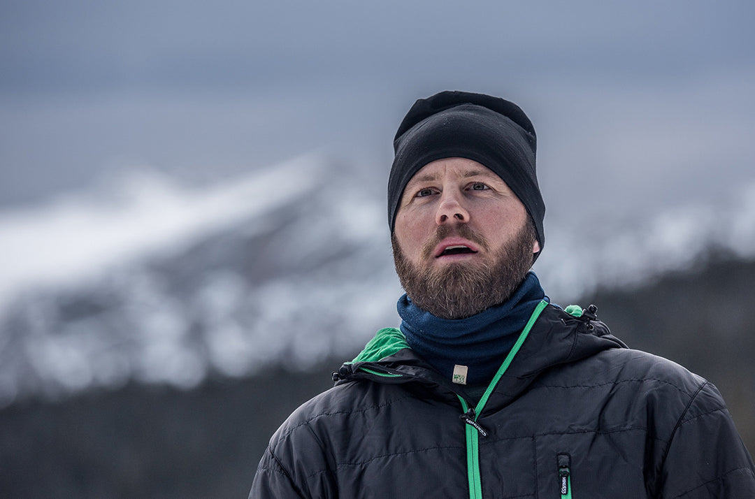 man snowshoeing wearing minus33 thermerino wool jacket