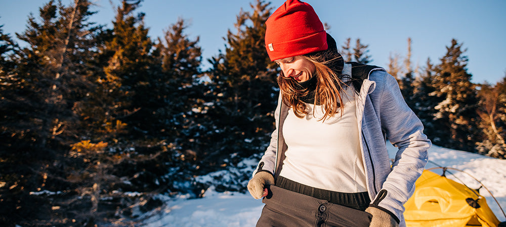 woman camping in the winter wearing kodiak fleece hoodie