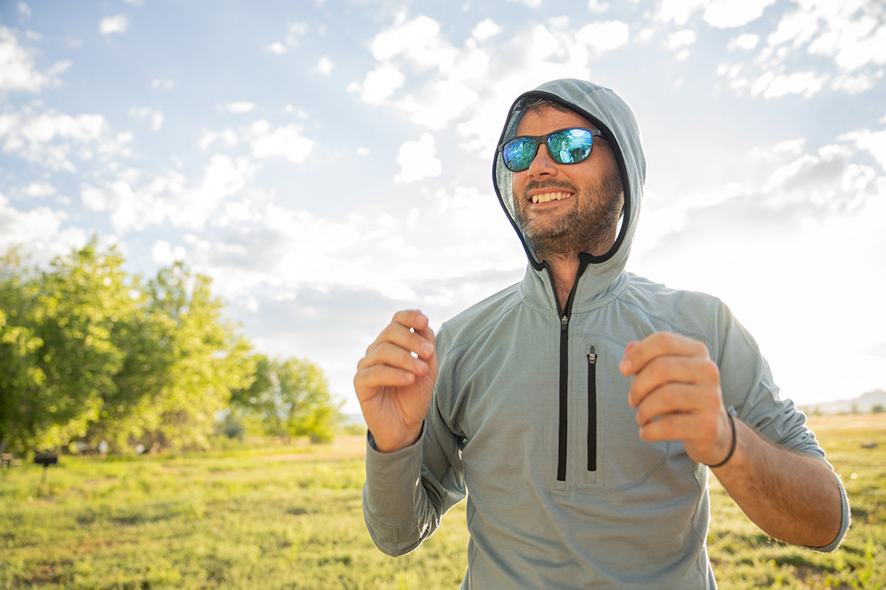 man wearing woolverino sun hoodie in slate blue