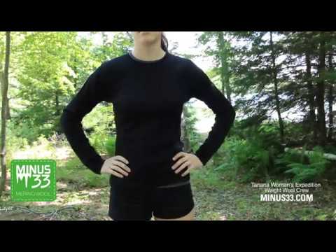 In a video, a woman models the one hundred percent merino wool heavyweight women's base layer crew top. This super soft top has a princess cut style for a more flattering fit. #color_black