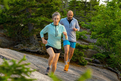 a women runs in a light blue sunhoodie 