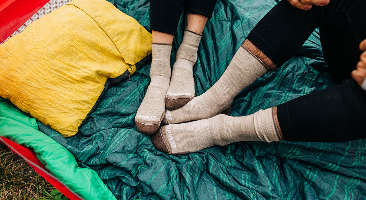people putting boots on wearing minus33 merino wool nh usa mountain heritage socks 