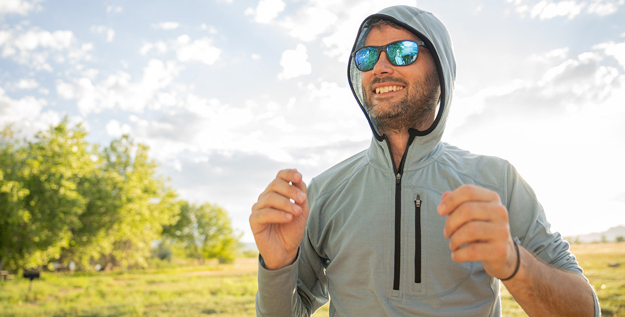 man wearing slate blue sun hoodie micro weight 1/4 zip