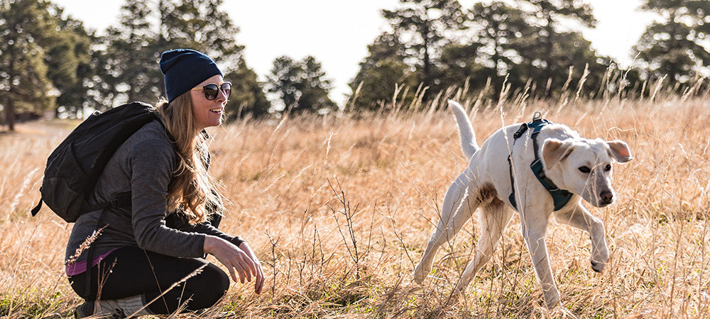 woman hiking with her dog wearing lightweight merino wool
