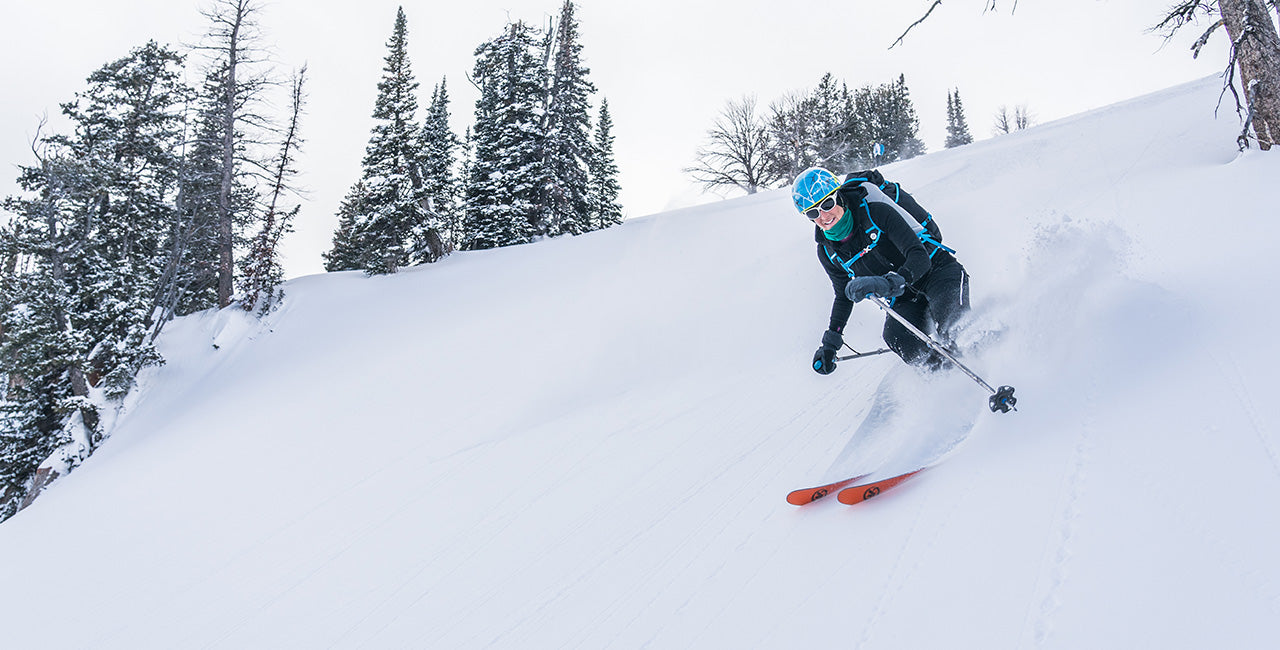 woman skiing wearing kodiak fleece expedition hoodie