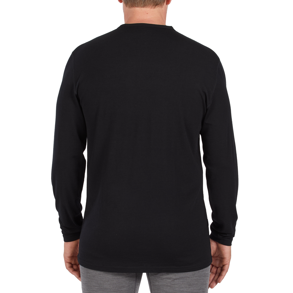 A man models the microweight long sleeved merino wool base layer crew neck top #color_black