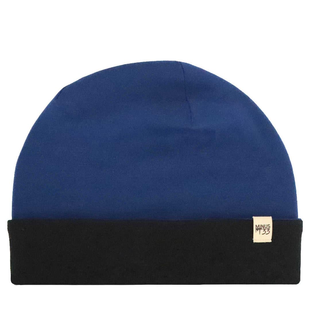 Flat lay image of the ridge cuff beanie. The color is navy blue and the cuff is black. 