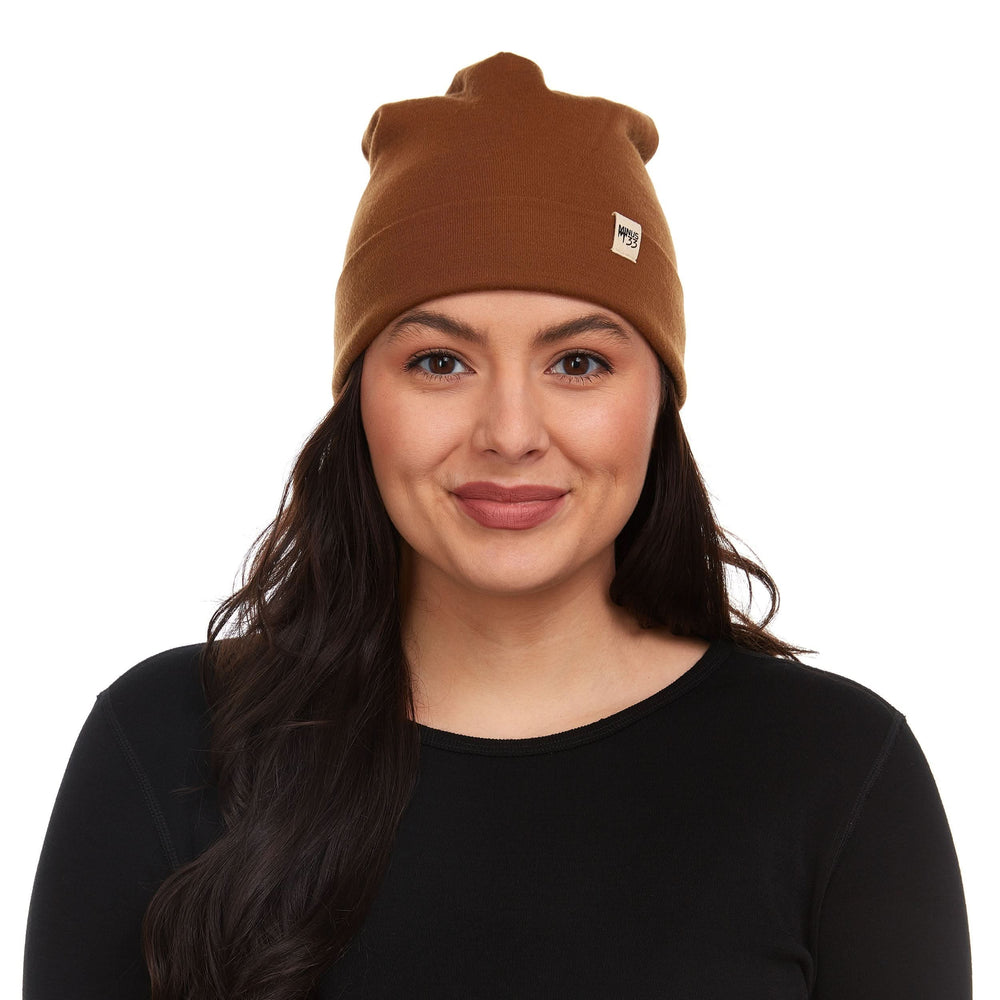 A woman models a lightweight, double-layered, hundred percent, super soft merino wool beanie perfect for fall, winter, and spring. This hat is perfect for a hike up the mountain or a walk around the block!
#color_golden-brown