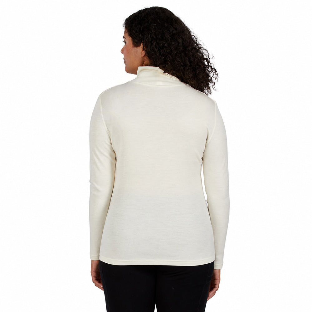 a cream-colored turtleneck sweater and black pants, merino wool #color_natural-cream