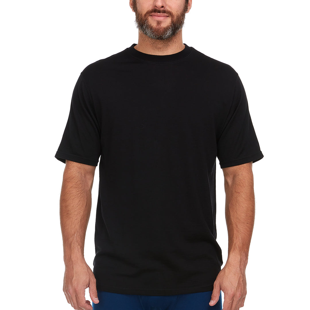 A man models a super soft, short sleeved merino wool thermal base layer crew. Use it as a base layer under your work shirt, or wear it all by itself during your next summer summit. #color_black