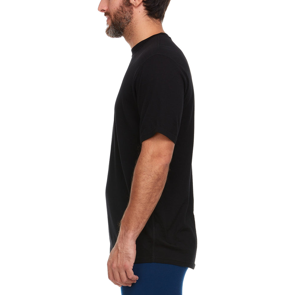 A man models a super soft, short sleeved merino wool thermal base layer crew. Use it as a base layer under your work shirt, or wear it all by itself during your next summer summit. #color_black