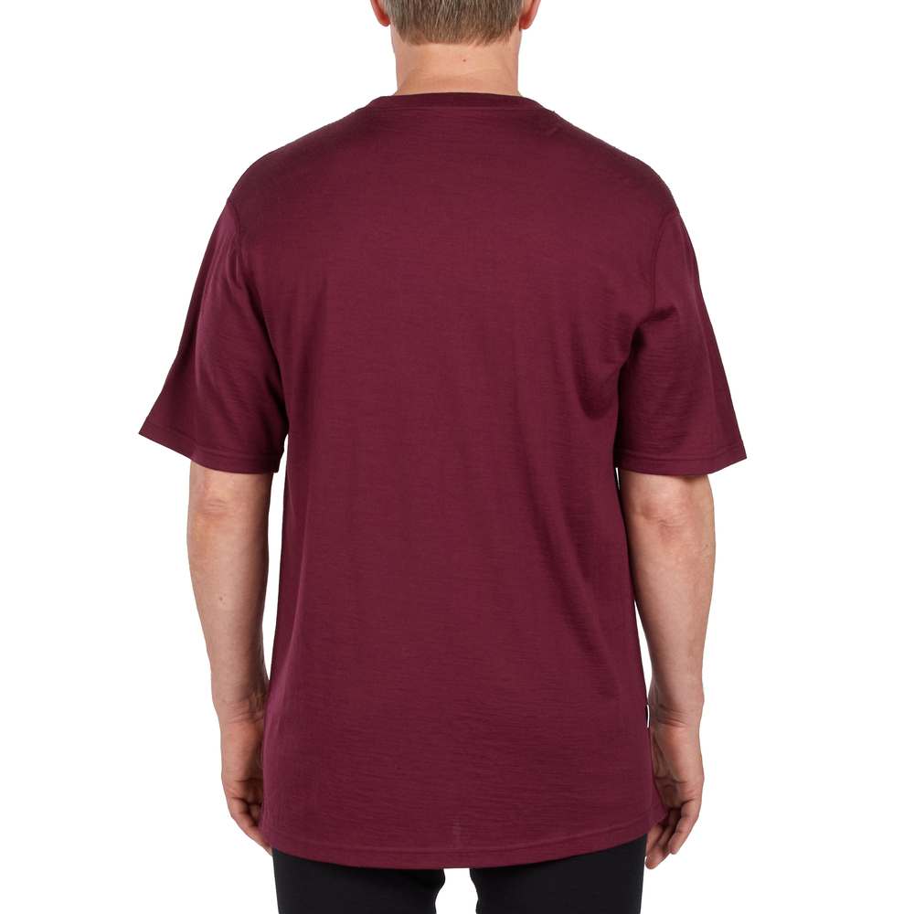 A man models a super soft, short sleeved merino wool t shirt. Use it as a base layer under your work shirt, or wear it all by itself during your next summer summit. #color_burgundy
