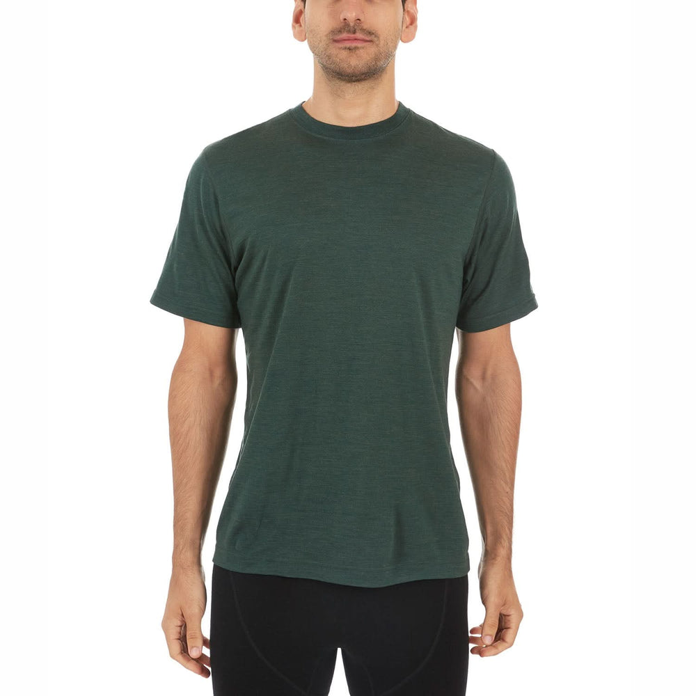 A man models a super soft, short sleeved merino wool t shirt. Use it as a base layer under your work shirt, or wear it all by itself during your next summer summit, front view #color_forest-green