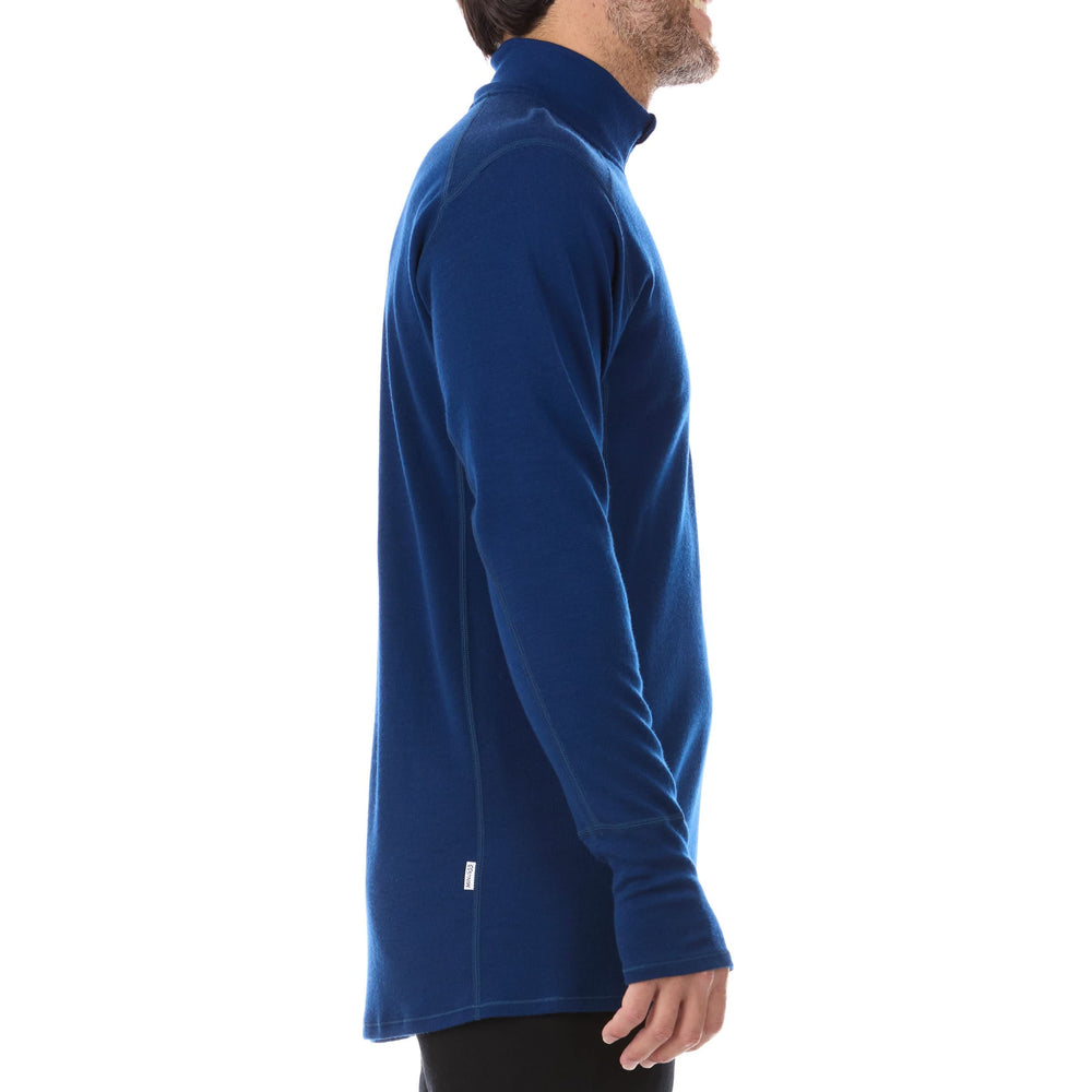 A man models the merino wool midweight quarter zip sweater, complete with flat-lock seams and thumbholes. #color_navy