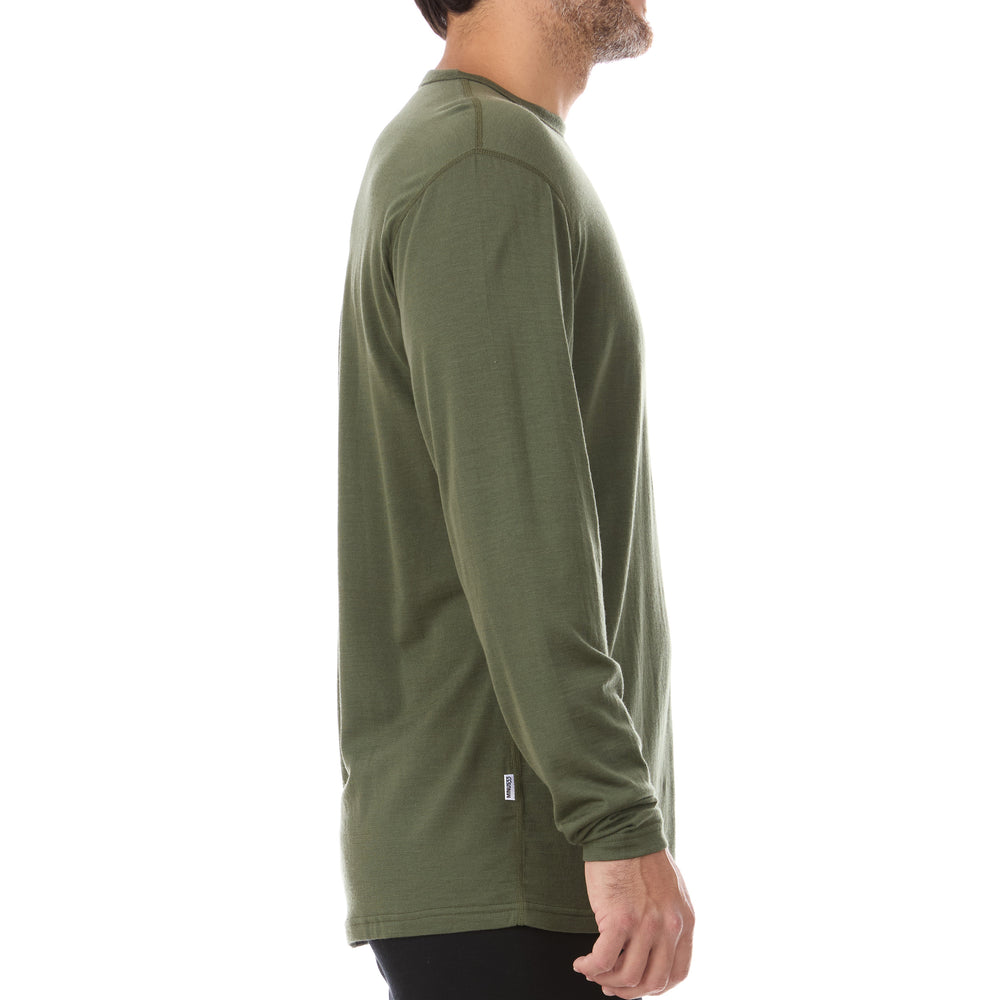 A man models the lightweight long sleeved merino wool base layer crew neck top #color_olive-drab-green