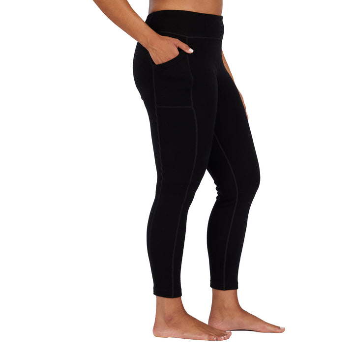 womens black expedition weight leggings side profile with hand in their pocket 