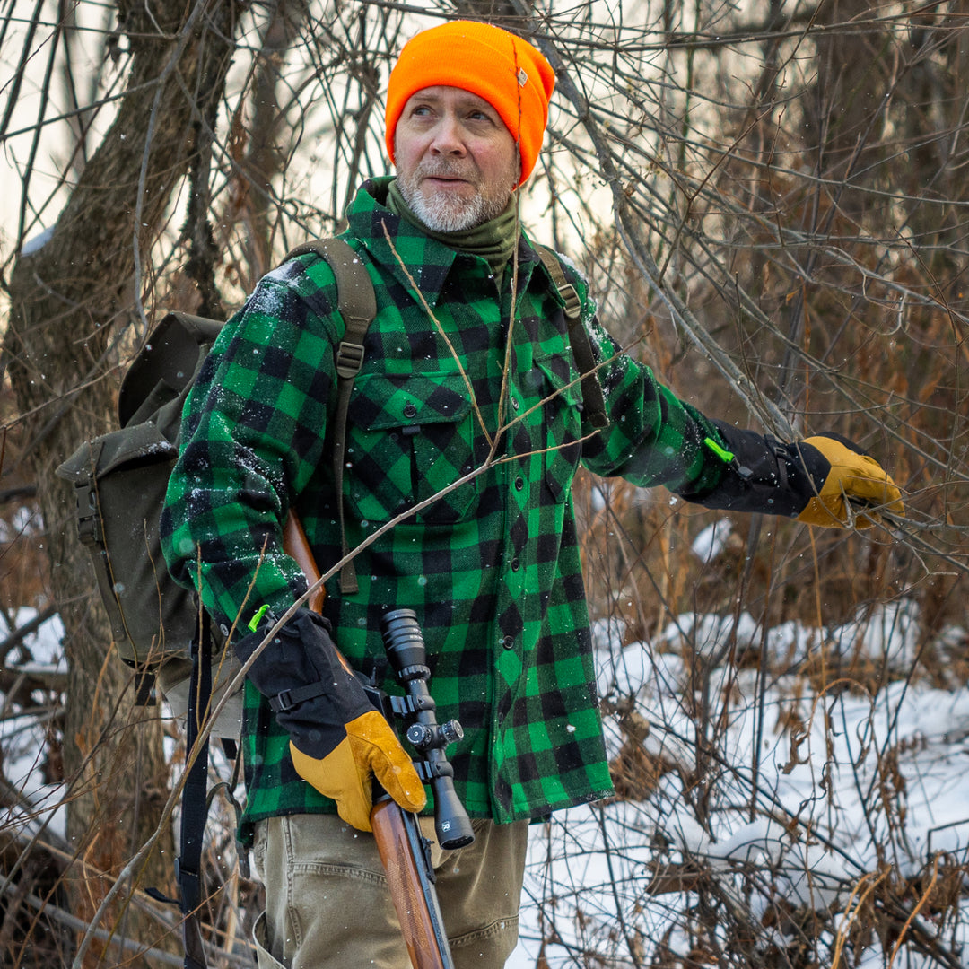 Hunter in Maine on a snowy day wearing a green Plaid Wool Shirt Jacket #color_green-plaid