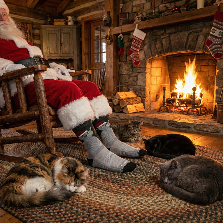 Santa wearing a pair of Merino wool cat socks