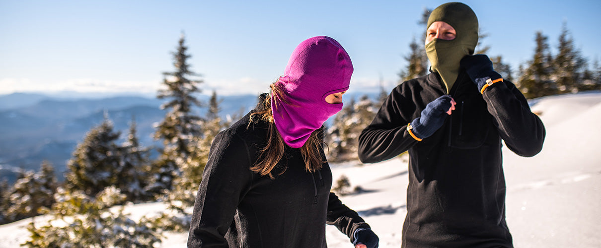 people hiking in the winter wearing midweight thermal layers and midweight balaclavas that are 100% merino wool